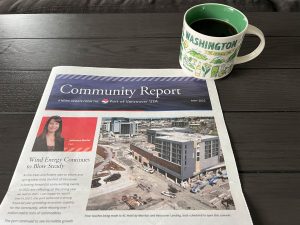 Community newsletter with cup of coffee on table